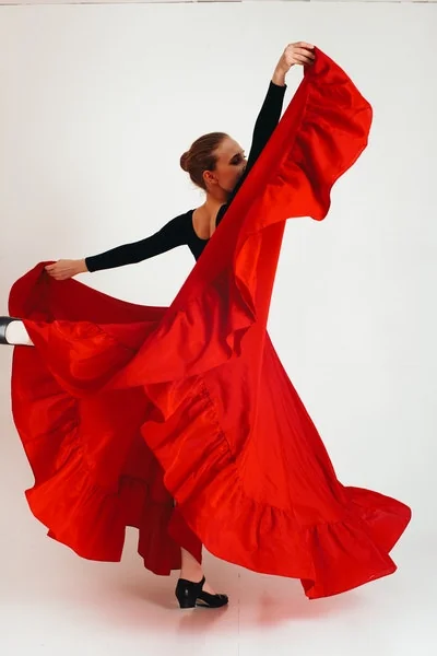 A dancer working on expressive arm and hand movement in a studio